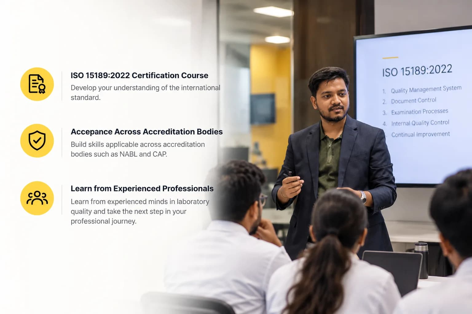 A Qualityveda trainer presenting ISO 15189:2022 to a group of laboratory professionals, with the screen listing Quality Management System, Document Control, Examination Processes, Internal Quality Control and Continual Improvement. Beside it: ISO 15189:2022 Certification Course: develop your understanding of the international standard. Acceptance Across Accreditation Bodies: build skills applicable across accreditation bodies such as NABL and CAP. Learn from Experienced Professionals: learn from experienced minds in laboratory quality and take the next step in your professional journey.